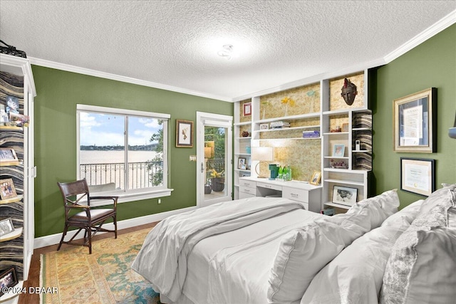 bedroom with light wood-type flooring, a textured ceiling, and crown molding