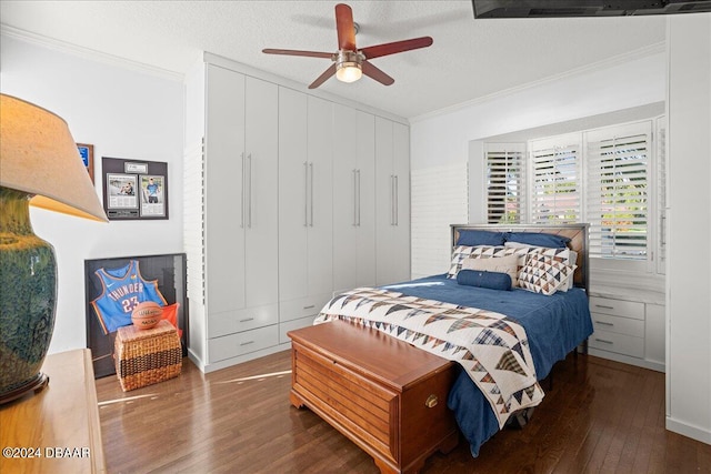 bedroom featuring ornamental molding, ceiling fan, dark hardwood / wood-style floors, a textured ceiling, and a closet