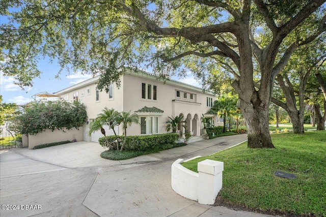 view of front of house with a garage and a front yard