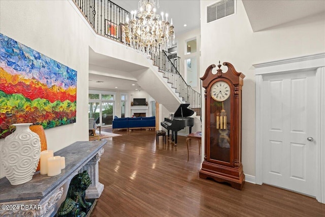 entrance foyer featuring a towering ceiling and dark hardwood / wood-style flooring