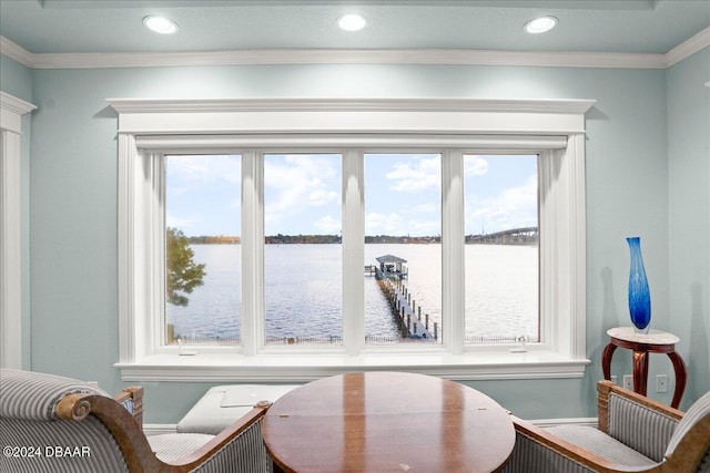 sitting room with a water view and ornamental molding