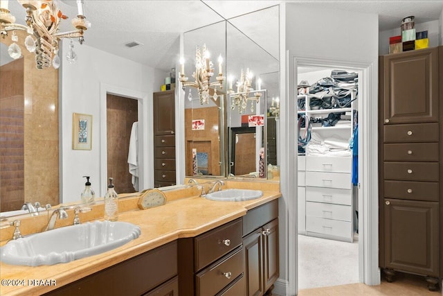 bathroom with vanity and a textured ceiling