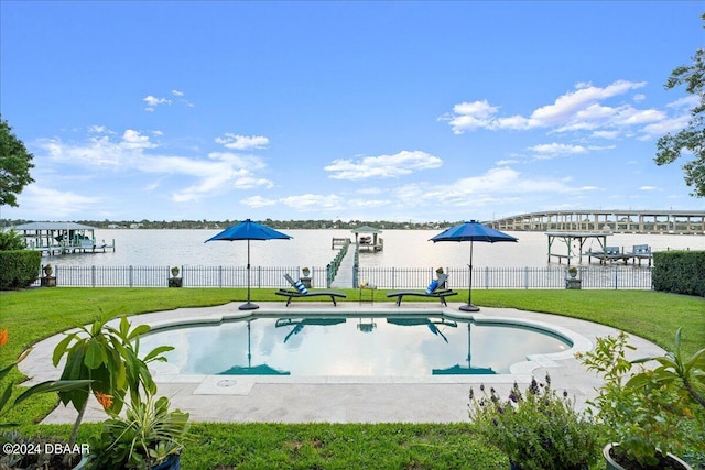 view of swimming pool with a water view and a yard