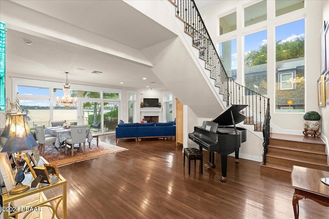 miscellaneous room with a chandelier, a textured ceiling, and dark hardwood / wood-style floors