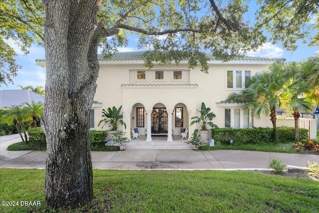 mediterranean / spanish-style house with a front lawn