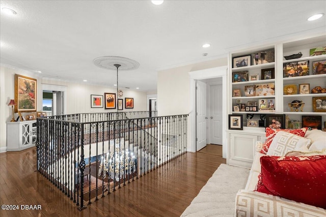 hall featuring dark wood-type flooring and ornamental molding