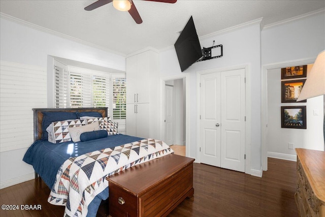 bedroom featuring dark wood-type flooring, ceiling fan, a closet, and crown molding