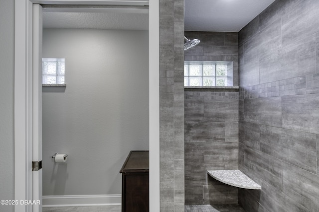 bathroom with a tile shower