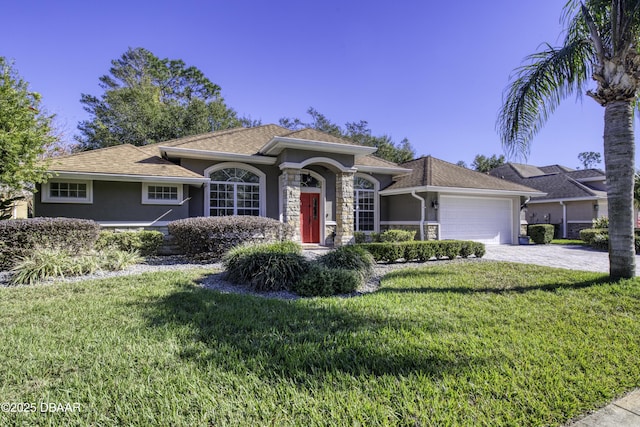 view of front of property with a garage and a front lawn