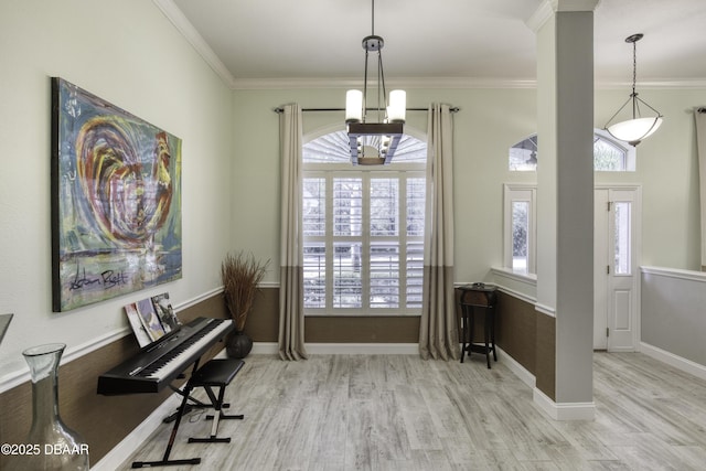 misc room with a chandelier, plenty of natural light, and crown molding