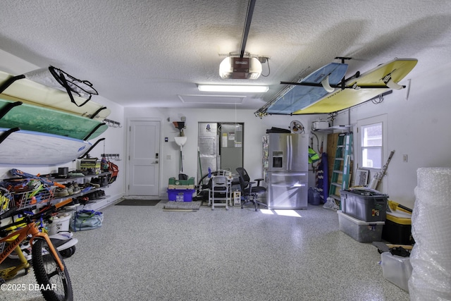 garage with stainless steel fridge with ice dispenser and a garage door opener