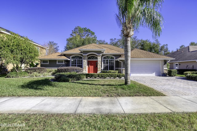 view of front of home with a garage and a front lawn