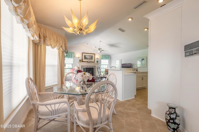 7 Fernery Trl, Ormond Beach, FL 32174 - dining area with a brick fireplace, a ceiling fan, lofted ceiling, baseboards, and light tile patterned flooring
