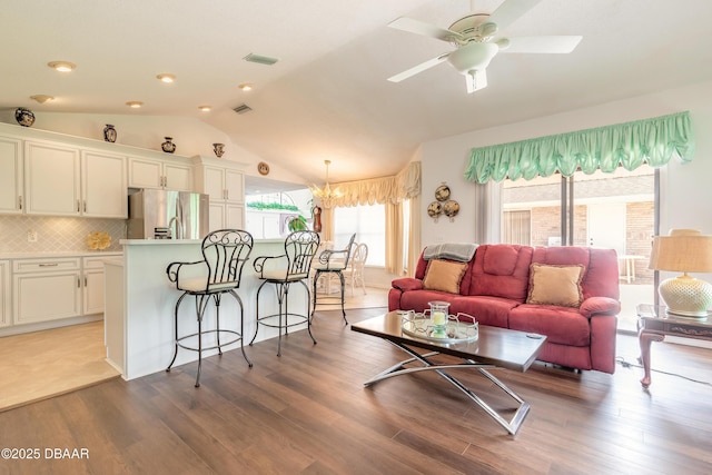 7 Fernery Trl, Ormond Beach, FL 32174 - living area with lofted ceiling, wood finished floors, a ceiling fan, and a chandelier