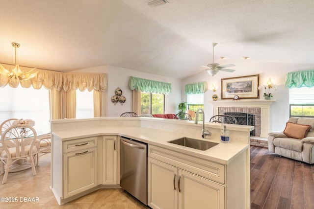 7 Fernery Trl, Ormond Beach, FL 32174 - kitchen with open floor plan, stainless steel dishwasher, a sink, light countertops, and cream cabinets
