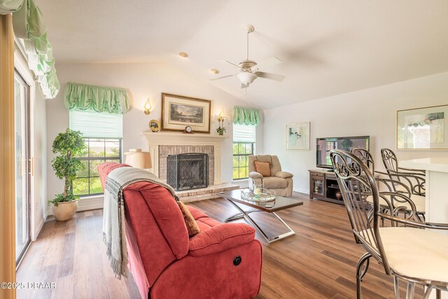 7 Fernery Trl, Ormond Beach, FL 32174 - living area with vaulted ceiling, ceiling fan, a brick fireplace, wood finished floors, and baseboards