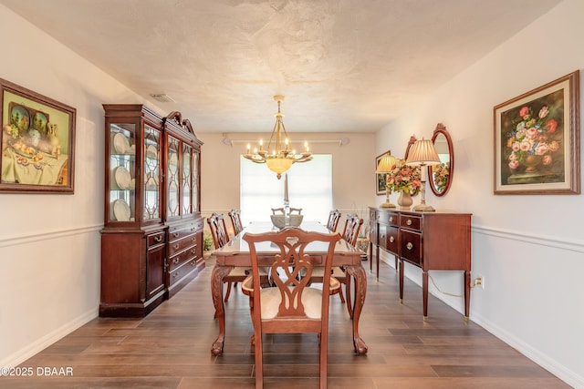 7 Fernery Trl, Ormond Beach, FL 32174 - dining area featuring a chandelier, dark wood-style flooring, and baseboards
