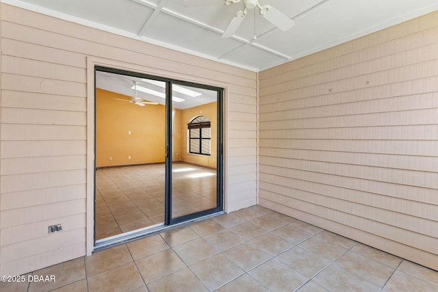 104 Herring Gull Ct, Daytona Beach, FL 32119 - spare room featuring ceiling fan, tile patterned flooring, and wood walls
