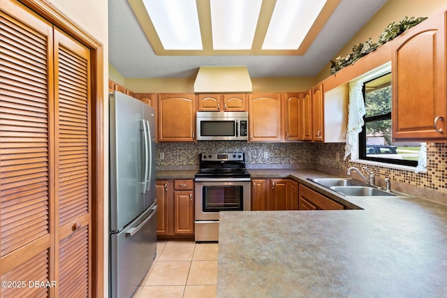 104 Herring Gull Ct, Daytona Beach, FL 32119 - kitchen with stainless steel appliances, backsplash, light tile patterned floors, and a peninsula