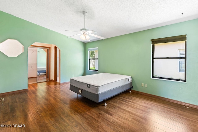 104 Herring Gull Ct, Daytona Beach, FL 32119 - bedroom featuring wood finished floors, a textured ceiling, ceiling fan, and arched walkways