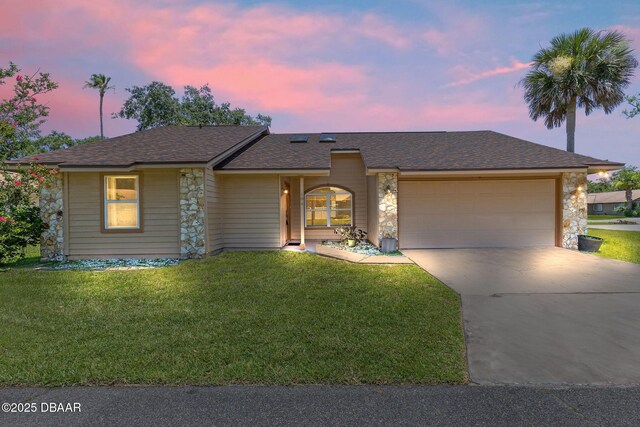 104 Herring Gull Ct, Daytona Beach, FL 32119 - view of front of property with stone siding, an attached garage, concrete driveway, and a front lawn