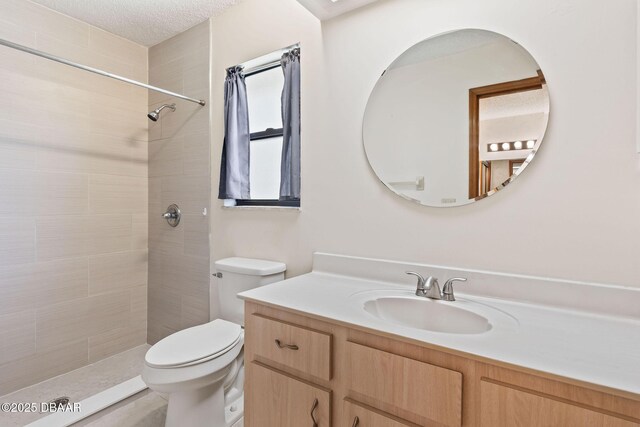 104 Herring Gull Ct, Daytona Beach, FL 32119 - full bathroom featuring vanity, tiled shower, and a textured ceiling