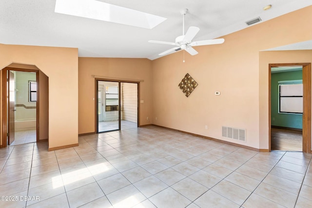 104 Herring Gull Ct, Daytona Beach, FL 32119 - unfurnished room featuring vaulted ceiling, light tile patterned flooring, a skylight, ceiling fan, and a smoke detector