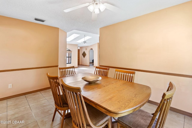104 Herring Gull Ct, Daytona Beach, FL 32119 - dining room featuring a ceiling fan, light tile patterned floors, and arched walkways