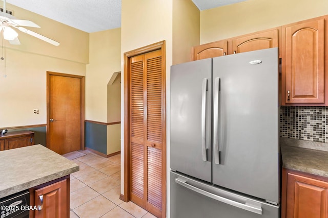 104 Herring Gull Ct, Daytona Beach, FL 32119 - kitchen with freestanding refrigerator, a ceiling fan, decorative backsplash, and light tile patterned floors