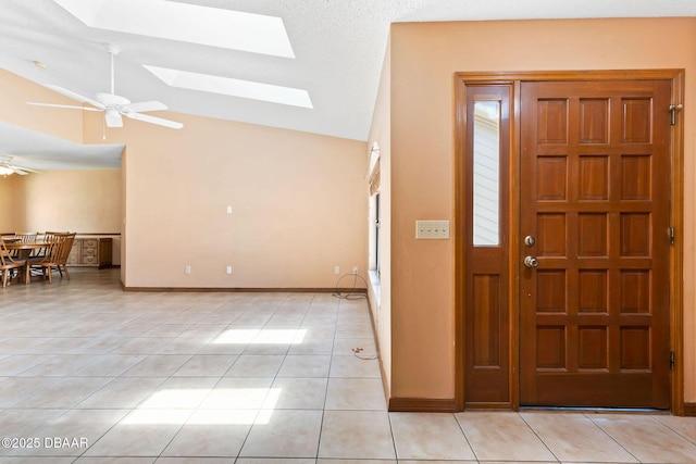 104 Herring Gull Ct, Daytona Beach, FL 32119 - entrance foyer with a ceiling fan, light tile patterned floors, a skylight, and high vaulted ceiling
