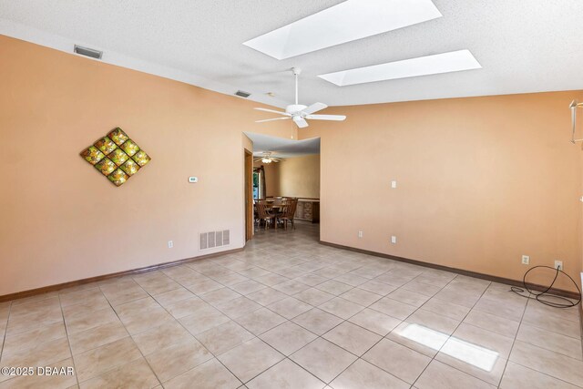 104 Herring Gull Ct, Daytona Beach, FL 32119 - unfurnished room with a skylight, light tile patterned flooring, ceiling fan, and lofted ceiling
