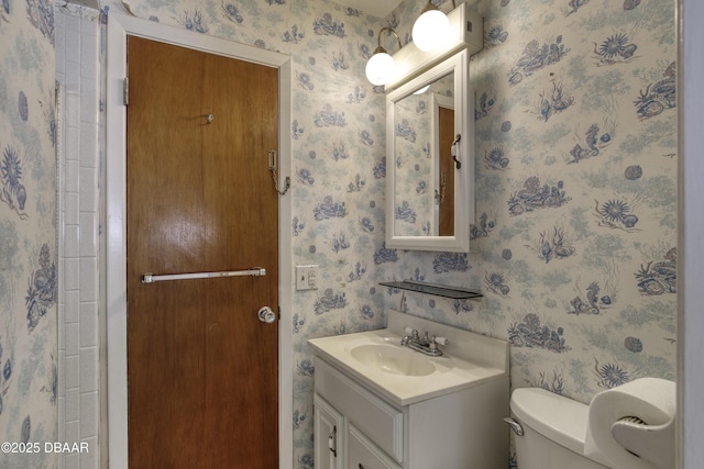 34 Kathy Dr, Ormond Beach, FL 32176 - bathroom with wallpapered walls, vanity, and toilet