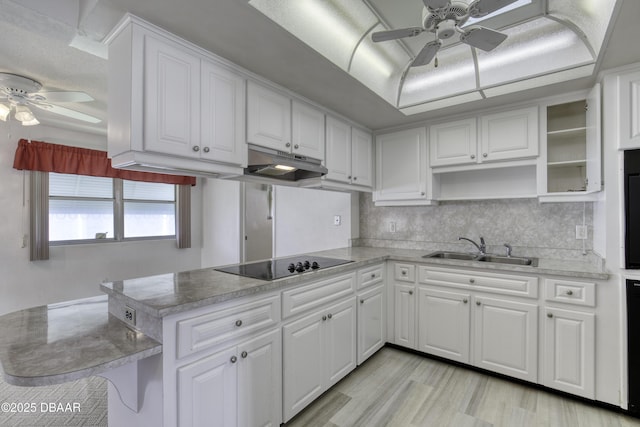 34 Kathy Dr, Ormond Beach, FL 32176 - kitchen featuring ceiling fan, black electric cooktop, a sink, under cabinet range hood, and white cabinetry