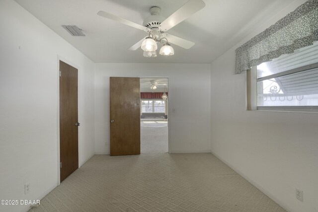 34 Kathy Dr, Ormond Beach, FL 32176 - carpeted empty room with a ceiling fan