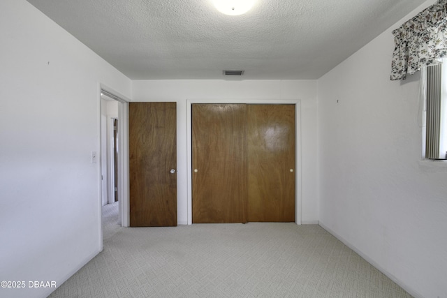 34 Kathy Dr, Ormond Beach, FL 32176 - unfurnished bedroom featuring carpet flooring, a closet, and a textured ceiling