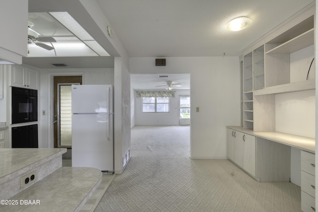 34 Kathy Dr, Ormond Beach, FL 32176 - kitchen with freestanding refrigerator, ceiling fan, oven, and light colored carpet