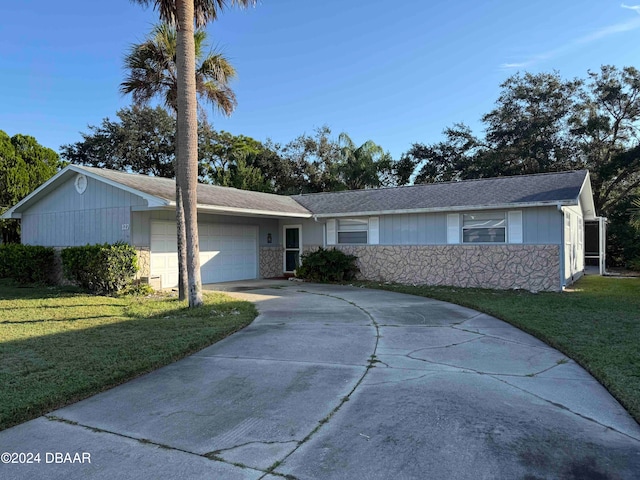 single story home featuring a front yard and a garage