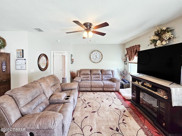 living room featuring carpet flooring and ceiling fan