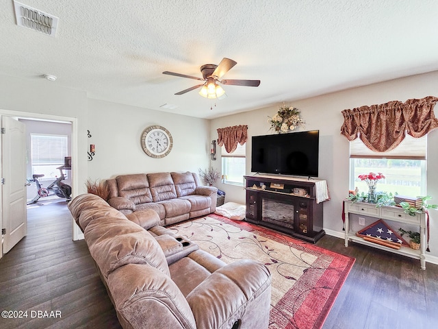 living room featuring dark hardwood / wood-style flooring, a healthy amount of sunlight, and ceiling fan