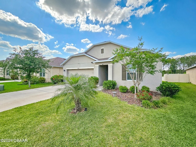 view of front of house featuring a garage and a front lawn