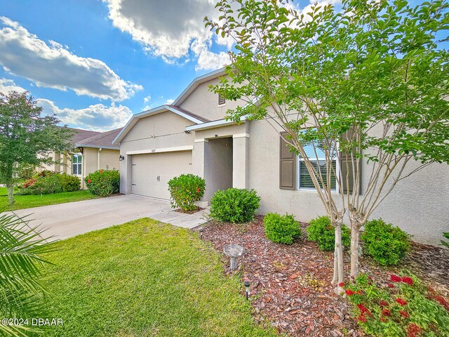 view of front of property with a garage and a front yard