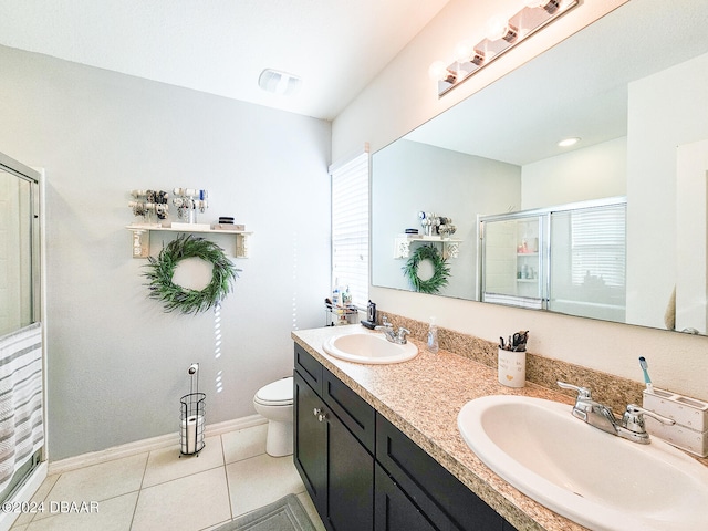 bathroom featuring a wealth of natural light, a shower with shower door, tile patterned flooring, and toilet