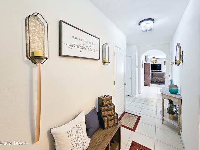 corridor featuring light tile patterned floors