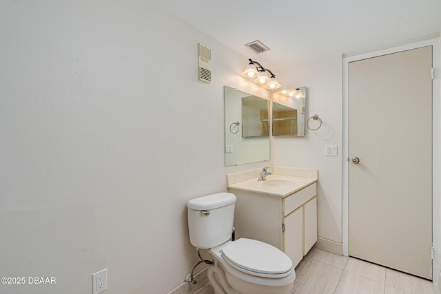 bathroom with tile patterned flooring, vanity, and toilet