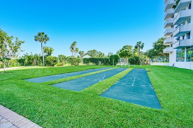 view of property's community with a lawn