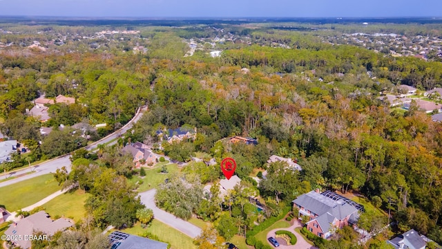 birds eye view of property with a wooded view