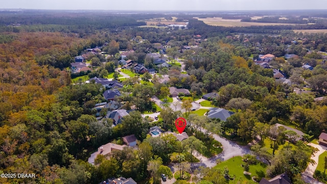 birds eye view of property with a residential view and a wooded view