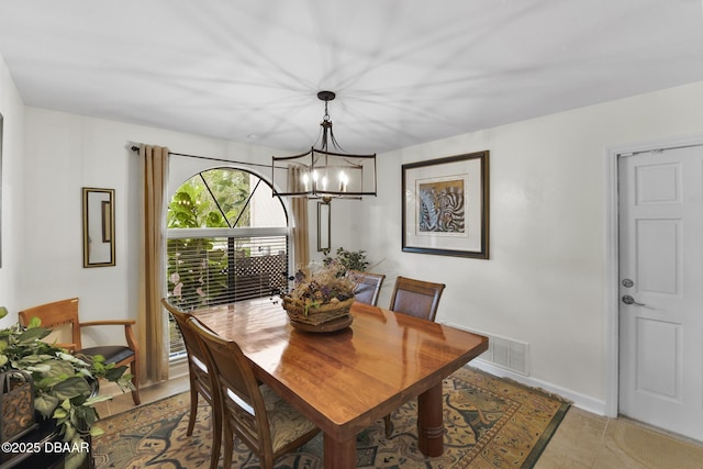 dining area featuring an inviting chandelier, baseboards, and visible vents