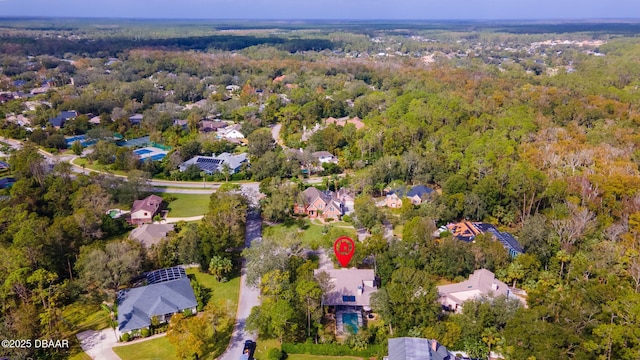 drone / aerial view with a residential view and a wooded view