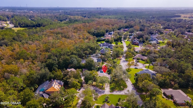 birds eye view of property with a view of trees